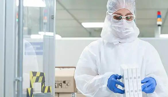 woman in PPE in lab