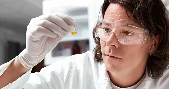 Lab man looking at a bottle